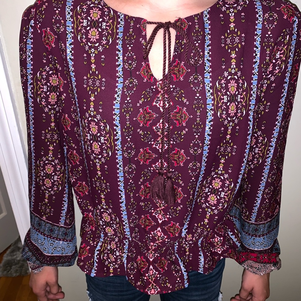 Francesca’s patterned blouse with tassels